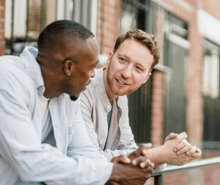 Two men talking over coffee about mental health and wellbeing