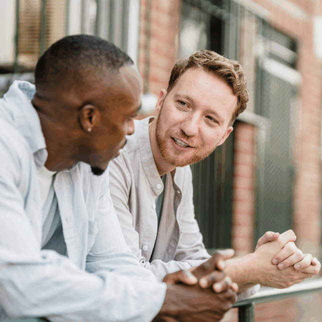 Two men talking over coffee about mental health and wellbeing