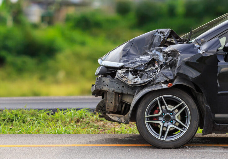 Front of black car get damaged by accident on the road