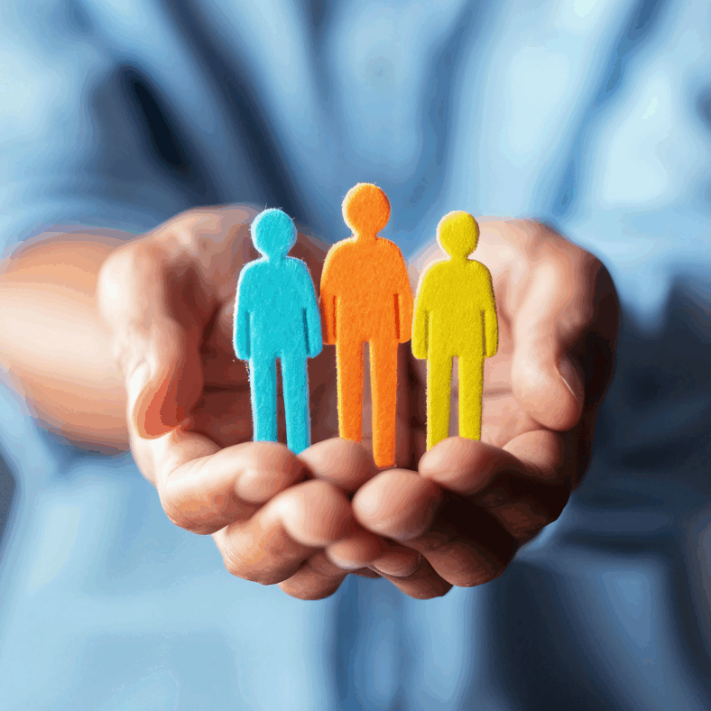 man holding three coloured felt people shapes to symbolise Safety First, Wellbeing Always